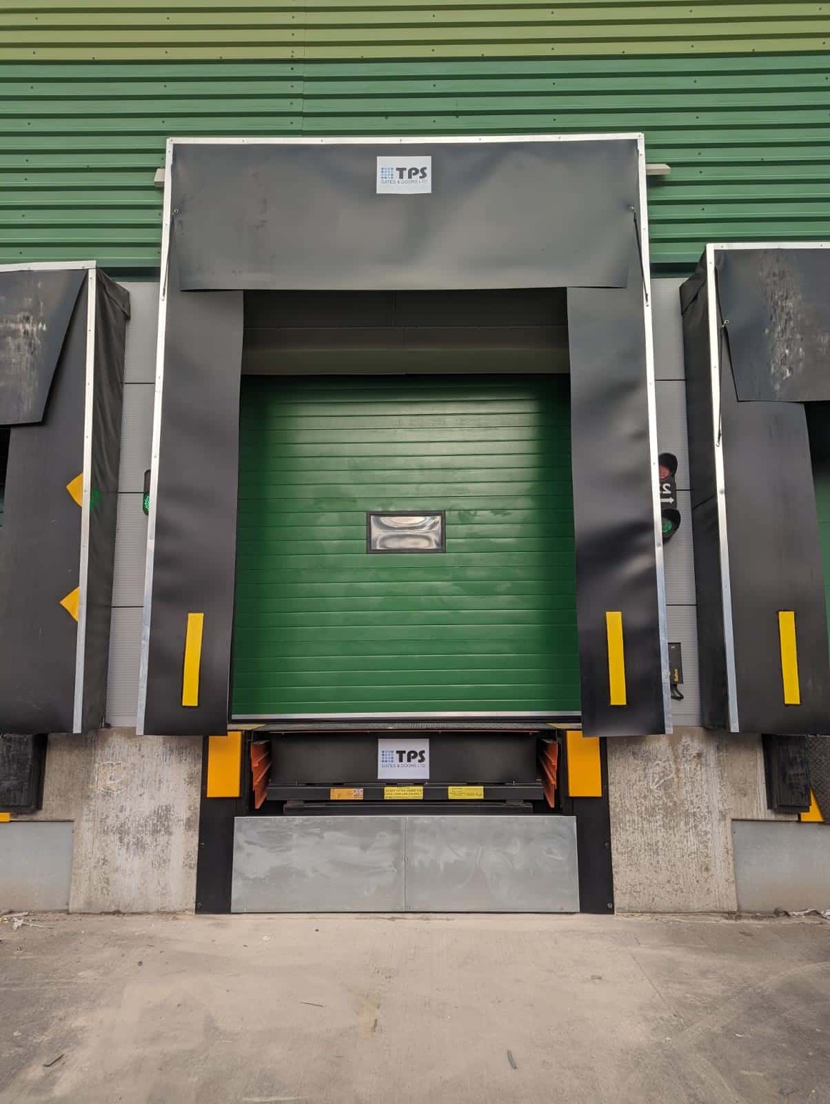 Warehouse loading bay with integrated hydraulic dock leveller, providing efficient truck docking and unloading, installed by TPS Industrial